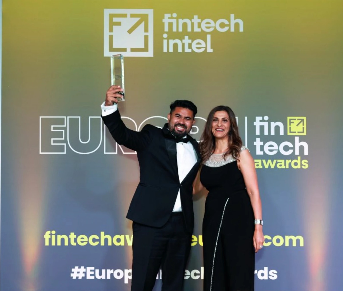 Mehedi Hasan raising the Rising Star of the Year trophy on stage beside the presenter at the European FinTech Awards 2026