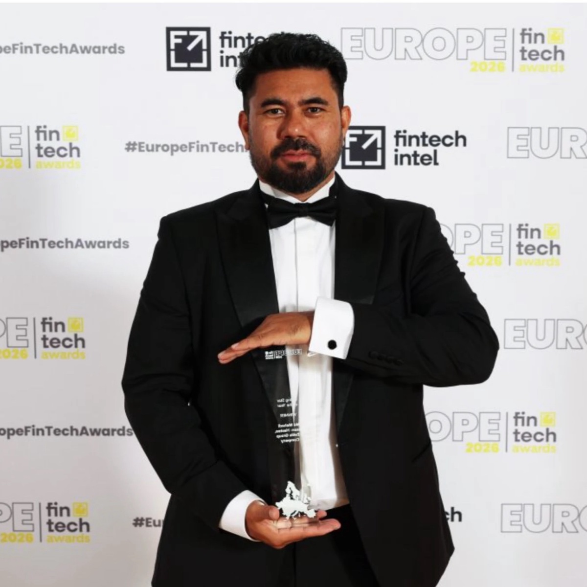 Mehedi Hasan in a black tuxedo and bow tie holding the Rising Star of the Year trophy at the European FinTech Awards 2026